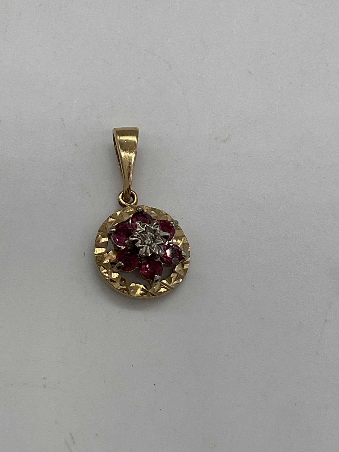 A yellow metal diamond and ruby circular flowerhead pendant with matching ear studs, combined - Image 2 of 4