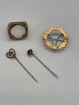 A 9ct yellow gold ring mount, a 9ct yellow gold brooch mount, and two yellow metal stick pins,