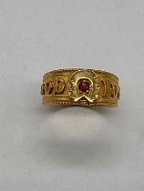 An 18ct yellow gold 'Good Luck' ring set with a ruby, size L, approx. 3.25g. Condition Report: The