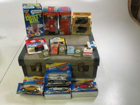 A suitcase containing a Dusty Bin money box and other items of interest, including some sweet and
