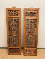 A pair of decorative carved oriental wooden panels, height 117cm, width 34cm