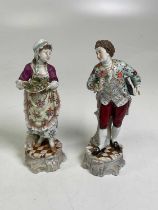 A pair of Continental porcelain figures boy with flower and girl with tray of fruit, height 25cm.