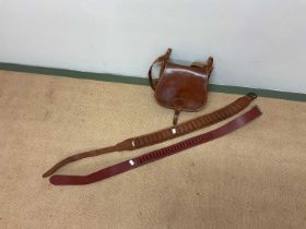 A shot gun leather case and two cartridge belts, large and small bore.