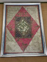 An unusual and large 19th century Indian embroidered panel set with various 'jewels' and with raised