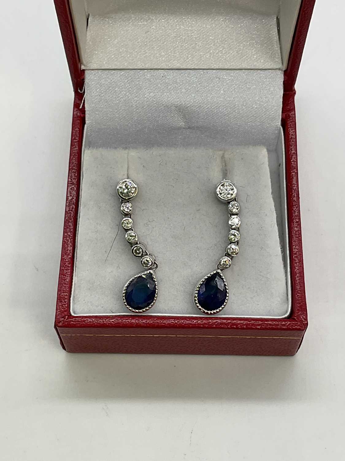 A pair of 18ct white gold diamond and sapphire drop earrings, each set with a pear shaped sapphire - Image 2 of 2