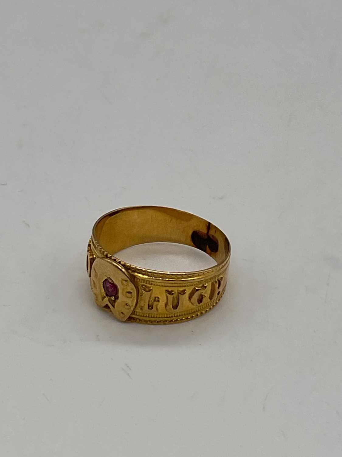 An 18ct yellow gold 'Good Luck' ring set with a ruby, size L, approx. 3.25g. Condition Report: The - Image 3 of 4