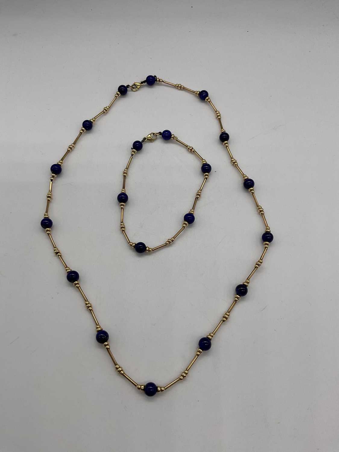 A 9ct yellow gold chain and bracelet set with bead spacers and blue roundels, necklace length