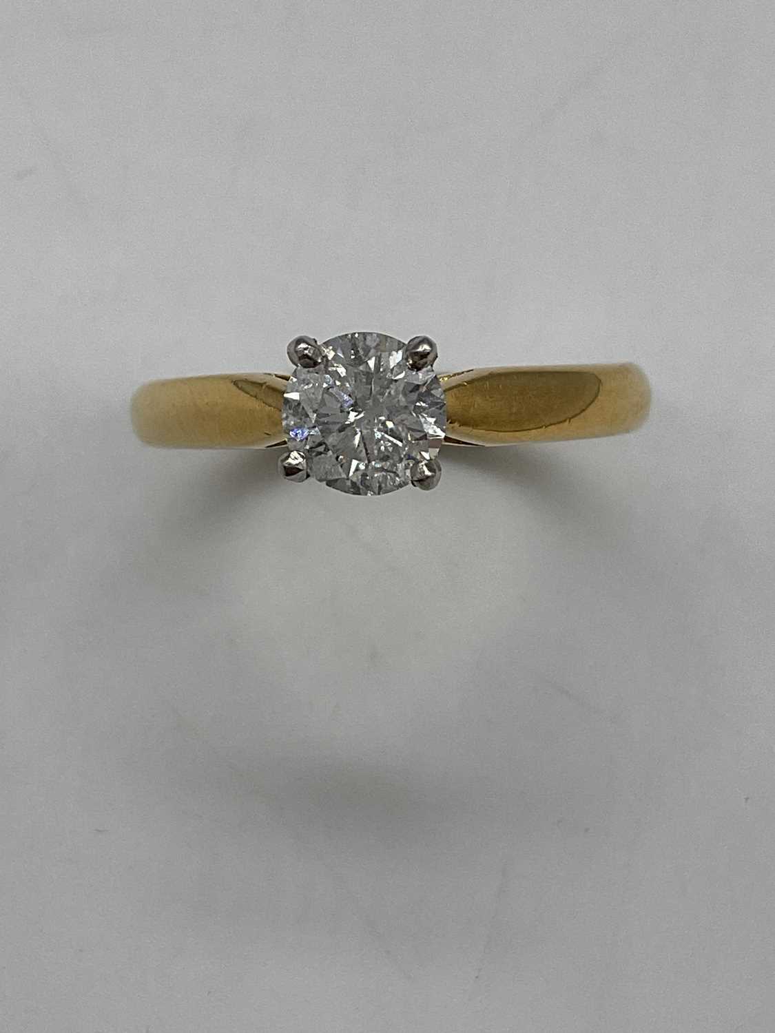 An 18ct yellow gold diamond solitaire ring, the four claw set round brilliant cut stone approx. 0.