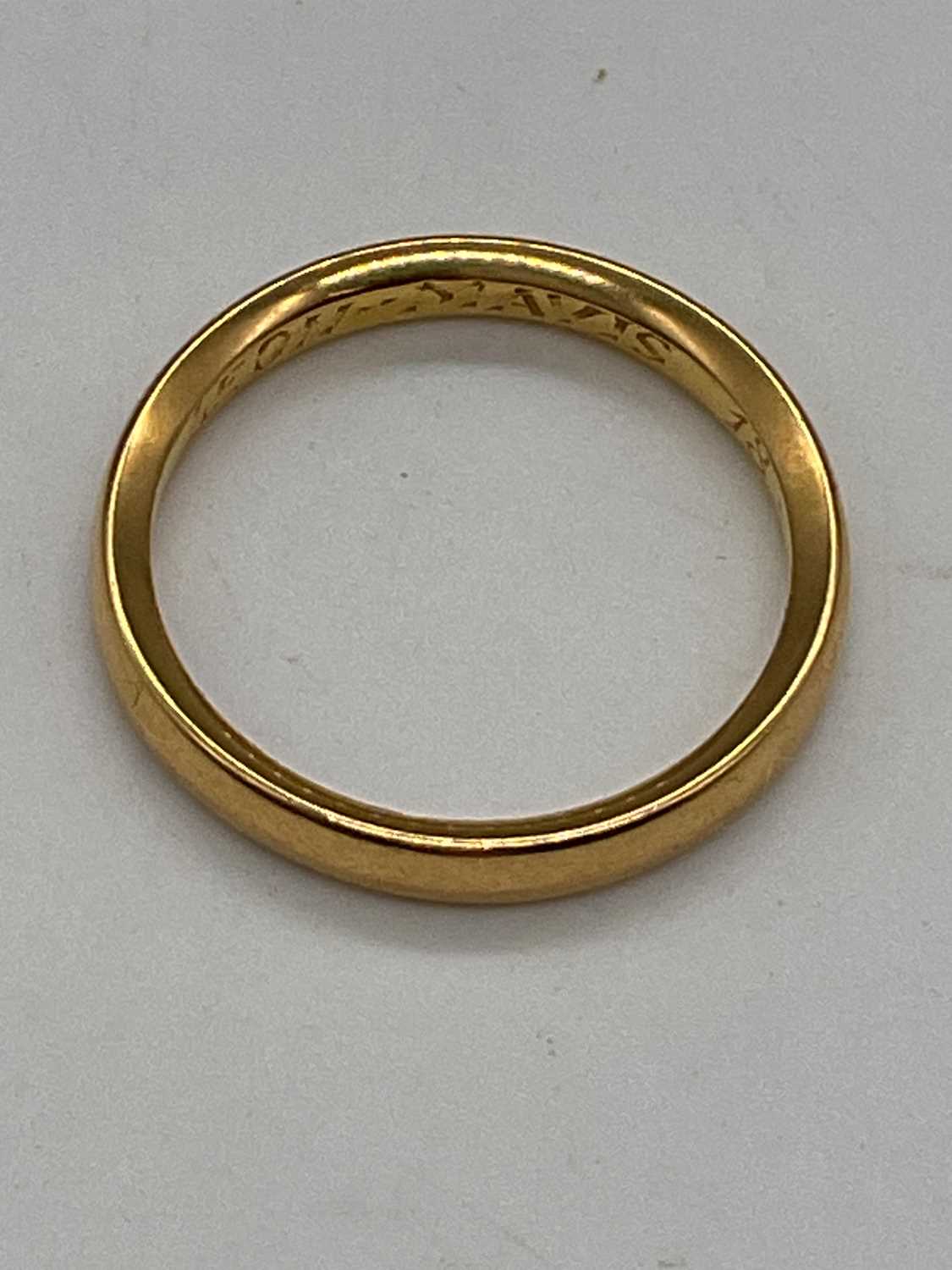 A yellow metal wedding band with inscription engraved to the inner band, size L, approx. 3.4g.