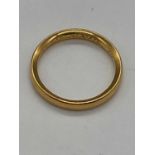 A yellow metal wedding band with inscription engraved to the inner band, size L, approx. 3.4g.