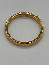 A yellow metal wedding band with inscription engraved to the inner band, size L, approx. 3.4g.