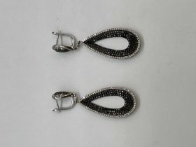 A pair of 18ct white gold black and white diamond set pierced drop earrings combined set with two