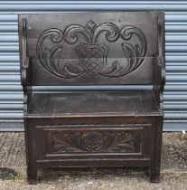 An early 20th century carved oak monk's bench, width 91cm.