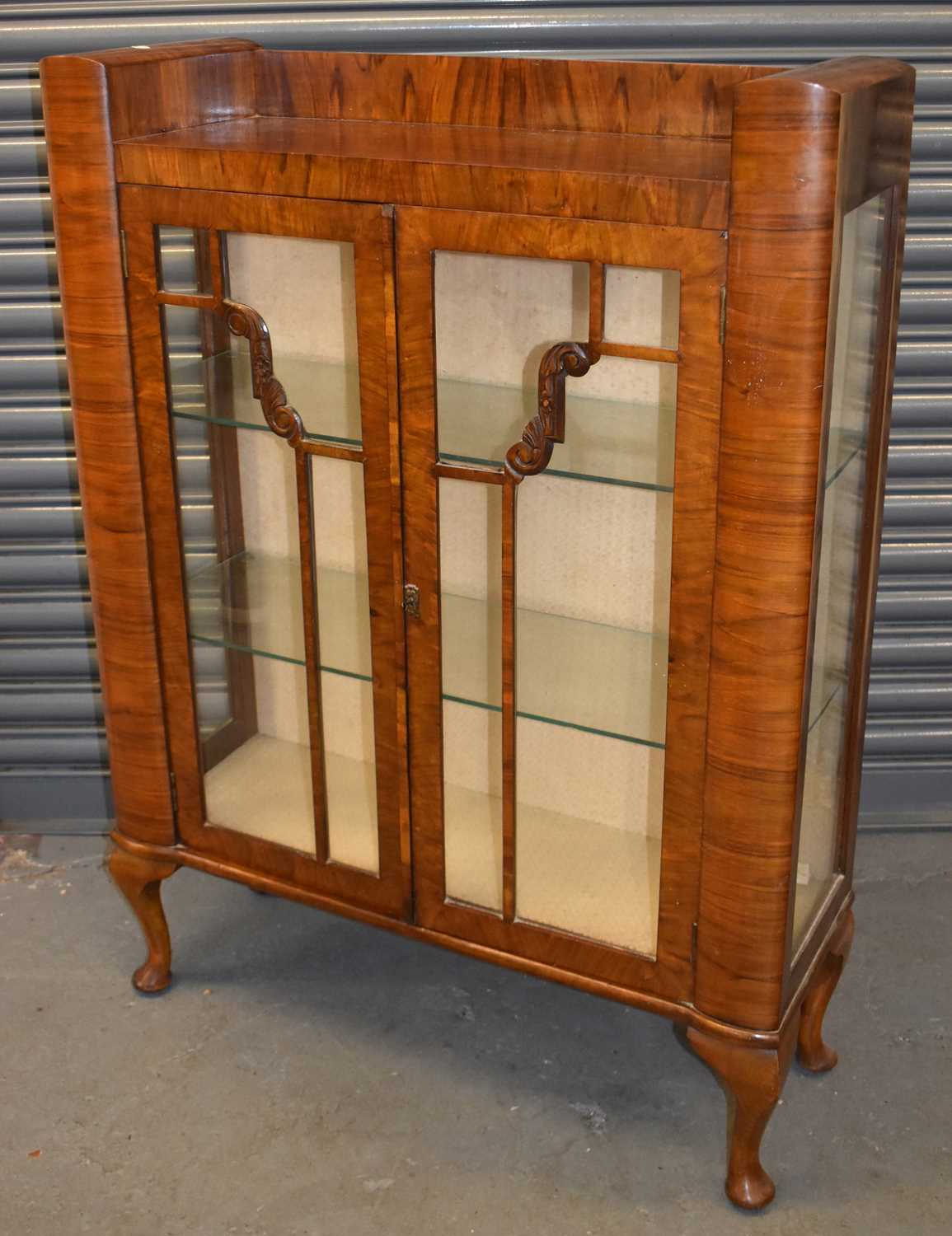 An Art Deco style walnut two door display cabinet on cabriole legs, width 87cm.