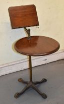A late Victorian adjustable reading table on brass column and cast iron base.