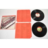 A Beatles 1962-1966 red vinyl record with red lyric inners and diagonally cut corners, 1973 original