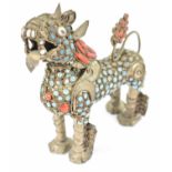 An early 20th century Tibetan brass scent bottle modelled as a Dog of Fo, set with turquoise and