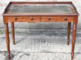 A Victorian mahogany writing table with green leather inset top above two frieze drawers on turned