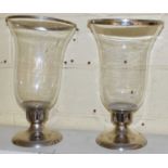 A pair of large glass storm lamps on plated metal bases, height 46.5cm.