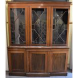 An Edwardian mahogany and line inlaid bookcase, with three doors above a breakfront base fitted with