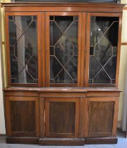 An Edwardian mahogany and line inlaid bookcase, with three doors above a breakfront base fitted with