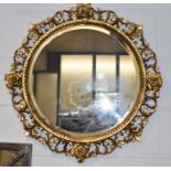 A gilt framed circular bevelled wall mirror, diameter 72cm.