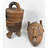 TRIBAL ART; an African carved wooden grain box with cover, height 44cm, and a Dogon mask with