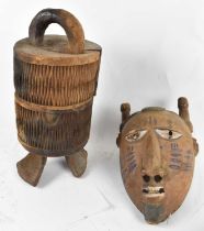 TRIBAL ART; an African carved wooden grain box with cover, height 44cm, and a Dogon mask with