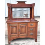 An Arts & Crafts mahogany sideboard, with mirror back above pair of doors and three drawers, with