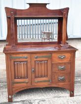 An Arts & Crafts mahogany sideboard, with mirror back above pair of doors and three drawers, with