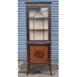 An early 20th century mahogany display cabinet with glazed door above bow fronted door, width
