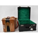 A modern Castagnari accordion in cherry finish, with hard case. Condition Report: Bellows are