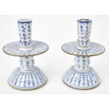 A pair of Chinese blue and white porcelain candlesticks decorated with characters, height 14cm.