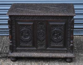 A small early 20th century carved oak coffer, width 76cm, height 60cm.