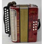 A Hohner Erica accordion with red marble finish, cased. Condition Report: Bellows are intact, all