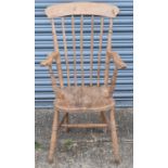 An elm seated kitchen Windsor elbow chair on turned supports.