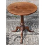 A 19th century mahogany occasional table with circular top on turned column and tripod supports,