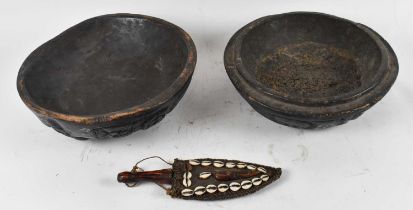 TRIBAL ART; a large African carved wooden bowl with cover, diameter 38cm and a dagger, the