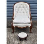A Victorian style walnut framed button upholstered spoon back armchair, also a modern footstool (