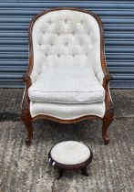 A Victorian style walnut framed button upholstered spoon back armchair, also a modern footstool (