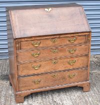 An 18th century oak bureau with fall front above four long drawers, width 86cm.
