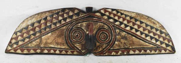 TRIBAL ART; a carved wooden Mou Shield, length 112cm.
