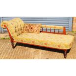 An Edwardian floral button upholstered chaise longue on ring turned supports.