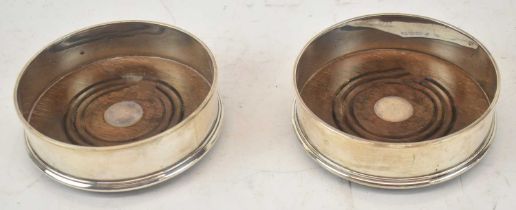 M C HERSEY & SON LTD; a pair of Elizabeth II hallmarked silver bottle coasters, diameter 12.5cm.