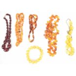A group of amber and amber coloured beads, comprising five necklaces and a bracelet (6).