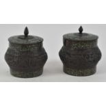 A pair of Japanese bronze and cloisonné pots with covers, the enamel providing a mosaic-like effect,