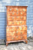 An 18th century walnut and crossbanded chest on chest, the upper section with three short and