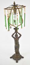 A late 19th century patinated spelter figural lamp with skeleton shade suspending several glass