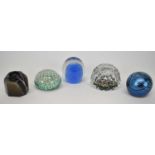 A Whitefriars glass paperweight, a Murano example, another by Norman Stuart Clarke, another