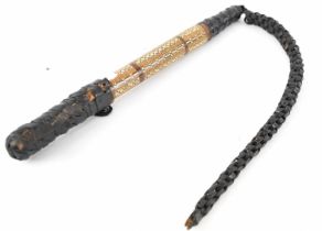 An Eastern camel whip with leather and inlaid handle, length 40cm.